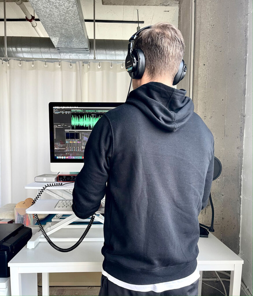 A Man Editing Voiceover Files on a Computer