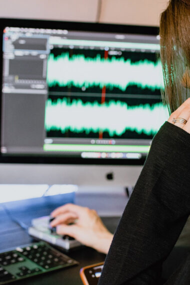 Woman editing sound files in adobe audition