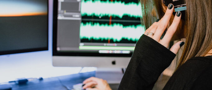 Woman editing sound files in adobe audition