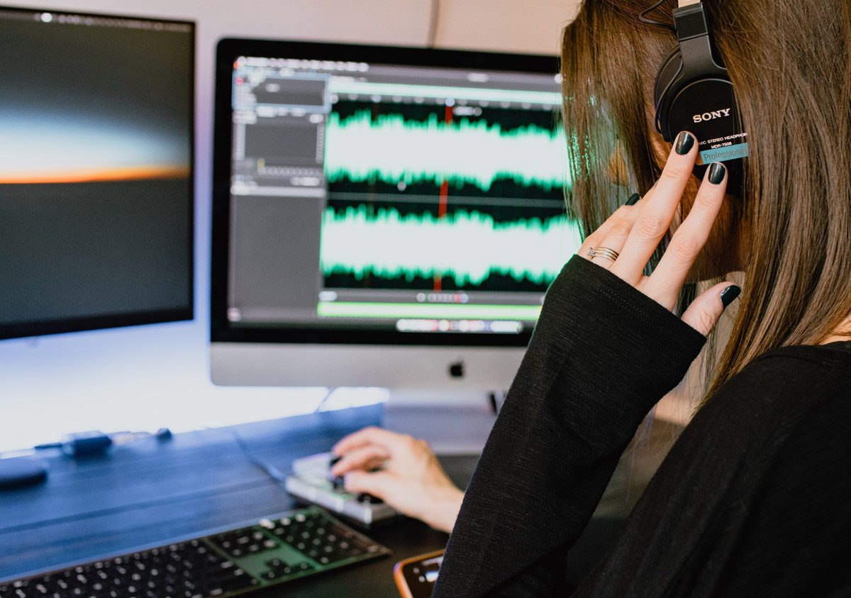 Woman editing sound files in adobe audition