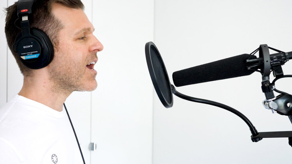 Voice Actor With Sony MDR 7506 Headphones and sennheiser microphone