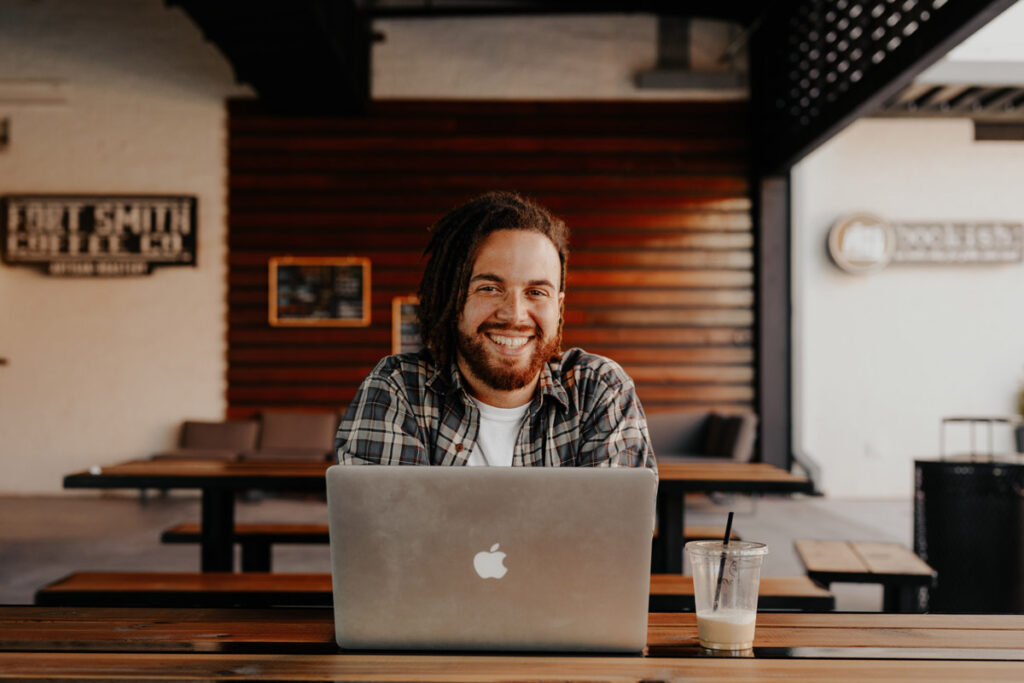 Smiling guy sending an email declining voice over work